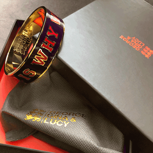 Gold Purple Cuff Bracelet with text, saying: “Love is why we are here.” By George Gina & Lucy Atelier Astrid & Antoinette